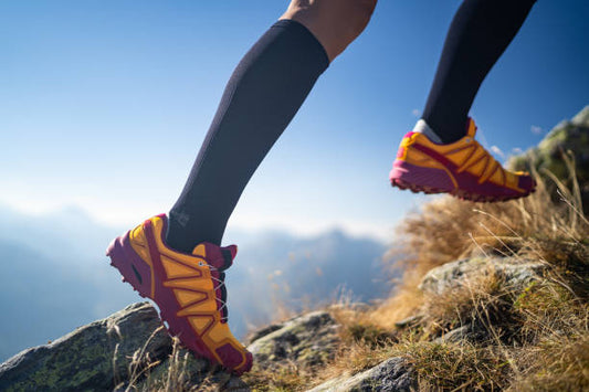 The image shows a man running with Compression Socks with a Zipper to improve sport performance.