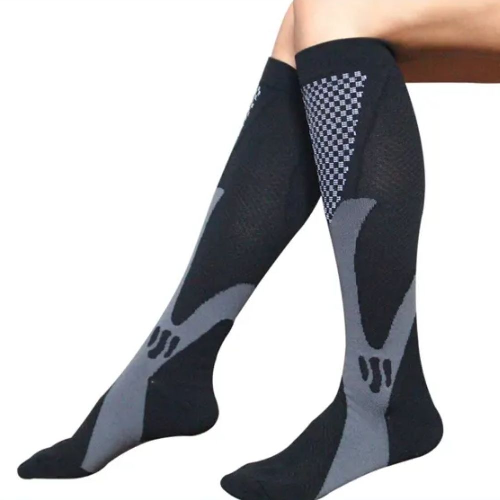 A leg of a woman wearing black color compression socks from Joocla.