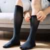 Man's leg wearing black color compression socks.
