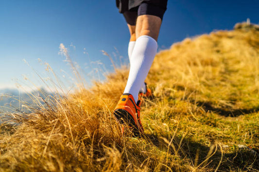 Running with 20-30 mmHg Compression socks to boost blood flow, reduce soreness, enhance recovery, and reach new heights.