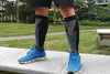 A man actively engaged in his run dons sleek black Joocla 20-30 mmHg Compression Socks, utilizing their supportive features to aid his legs during the exercise.