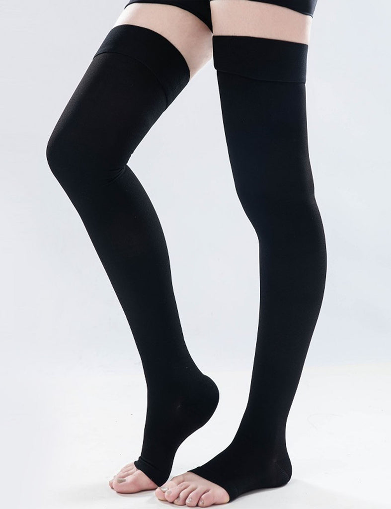 Woman's leg showing black color Thigh High Open-Toe Compression Socks.