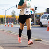 The image shows a runner wearing Copper-Infused Compression Socks 