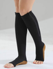 Woman's leg standing wearing black color premium zip up compression socks with open toe feature.